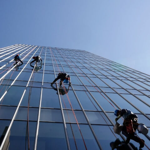 window washers on a glass tower